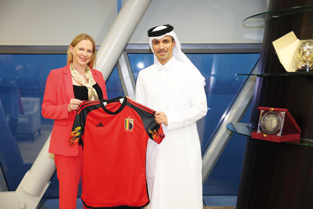 Qatar Football Association President Jassim bin Rashid Al Buenain receives a Belgium team jersey from President of the Royal Belgian Football Association Pascale Van Damme. 