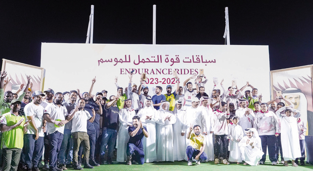 Participants and officials pose for a group photo after the season-opening race.   