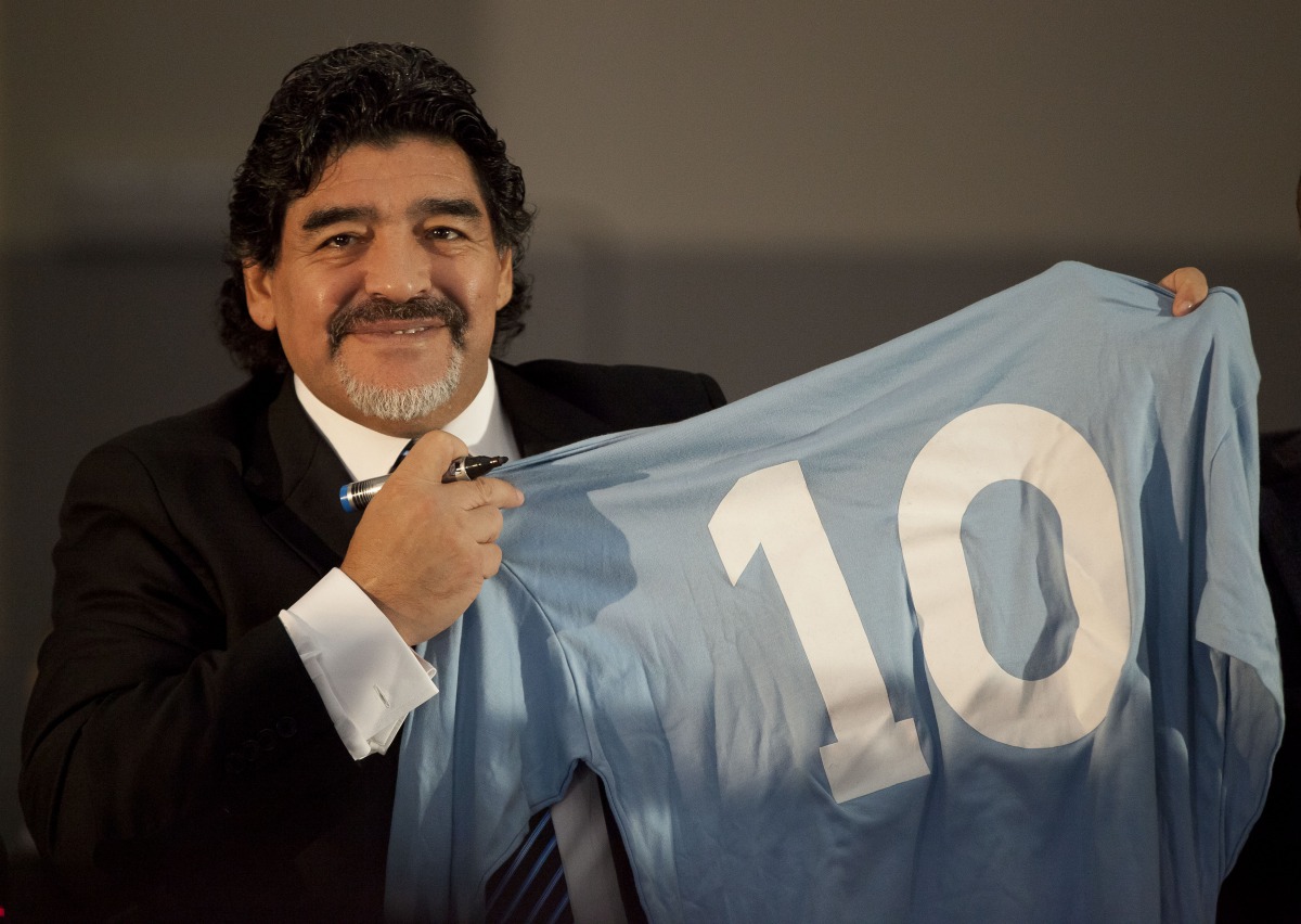 In this file photo taken on February 26, 2013, football legend Argentinian Diego Maradona holds a SSC Napoli number 10 jersey during a press conference in Naples. (AFP)

