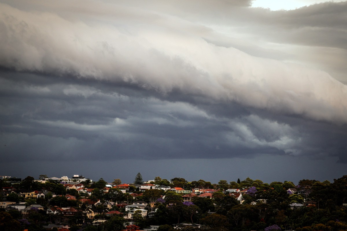 Storm clouds move over houses in northern Sydney on November 9, 2023. (Photo by DAVID GRAY / AFP)