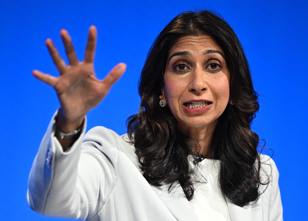 Britain's Home Secretary Suella Braverman addresses delegates at the annual Conservative Party Conference in Manchester, northern England, on October 3, 2023. Photo by Oli SCARFF / AFP