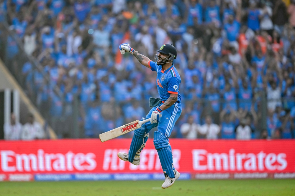 India's Virat Kohli celebrates after scoring a century (100 runs) at the Wankhede Stadium in Mumbai on November 15, 2023. (Photo by Indranil Mukherjee / AFP) 