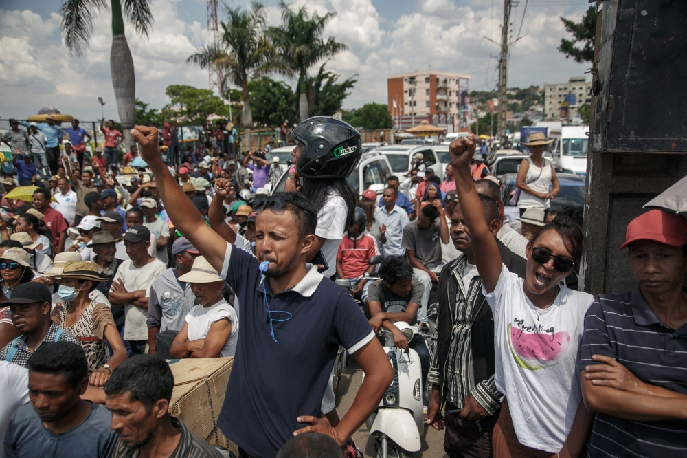 Supporters cheer as members of the collective of opposition candidates march through the streets of Analamahitsy district to protest against the holding of the 2023 Presidential Election, in Antananarivo, on November 14, 2023. 
