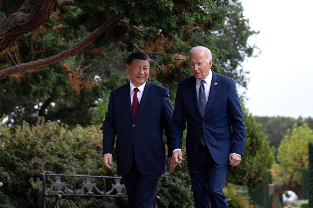 US President Joe Biden (right) and Chinese President Xi Jinping walk together after a meeting during the Asia-Pacific Economic Cooperation (APEC) Leaders' week in Woodside, California on November 15, 2023. (Photo by Brendan Smialowski / AFP)