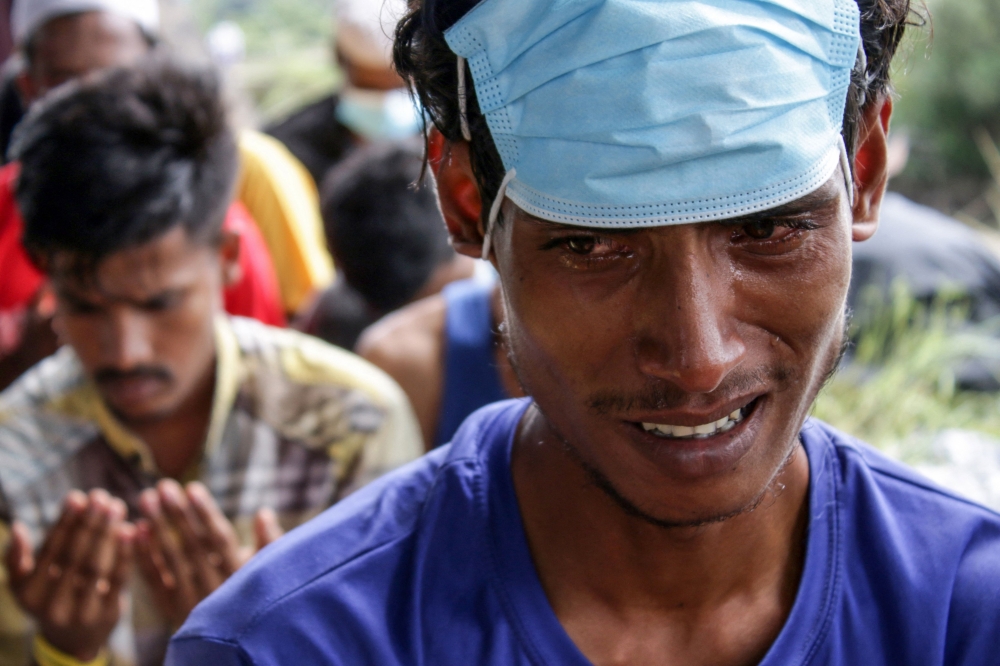 Rohingya refugees offer congregational prayers at a temporary shelter in Lapang Barat village, Bireuen, Aceh province on November 21, 2023. (Photo by Zikri Maulana and Zikri MAULANA / AFP)
