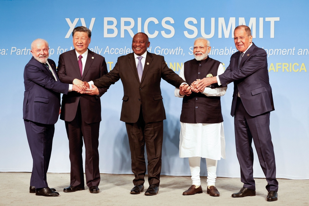 From left: President of Brazil Luiz Inacio Lula da Silva, President of China Xi Jinping, South African President Cyril Ramaphosa, Prime Minister of India Narendra Modi and Russia's Foreign Minister Sergei Lavrov during the 2023 BRICS Summit at the Sandton Convention Centre in Johannesburg, South Africa, on August 23, 2023. (Photo by Gianluigi Guercia / POOL / AFP)