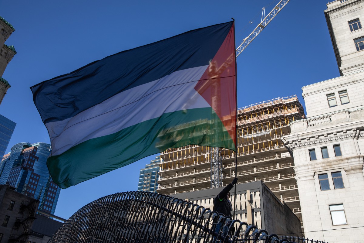 Demonstrators in support of Palestinians hold a rally to call for a ceasefire, at Dorchester Square in Montreal, Quebec, Canada, on November 18, 2023. (Photo by Alexis Aubin / AFP)