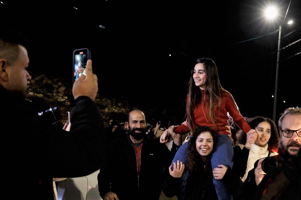 Newly released Palestinian prisoner Rouba Assi is carried by supporters during a welcome ceremony for prisoners freed from Israeli jails in exchange for Israeli hostages released by Hamas from the Gaza Strip, during a welcome ceremony in Ramallah in the occupied West Bank on November 28, 2023. (Photo by Kenzo Tribouillard / AFP)