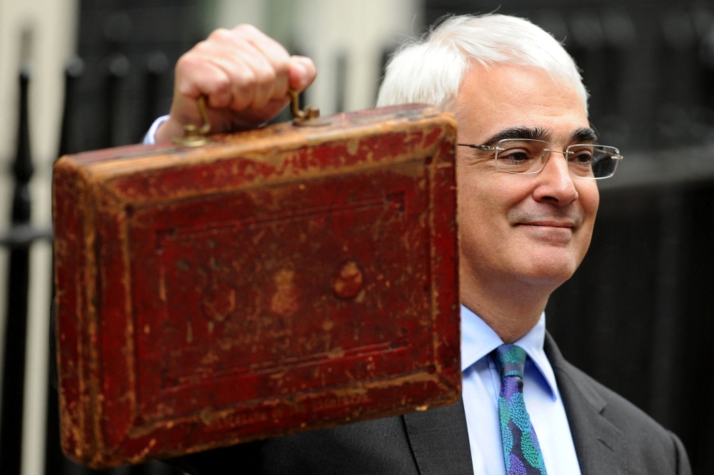 (FILES) Britain's Finance Minister Alistair Darling poses for pictures with a briefcase containing the 2010 Budget Report at a photocall outside 11 Downing Street in London, on March 24, 2010. (Photo by Ben STANSALL / AFP)
