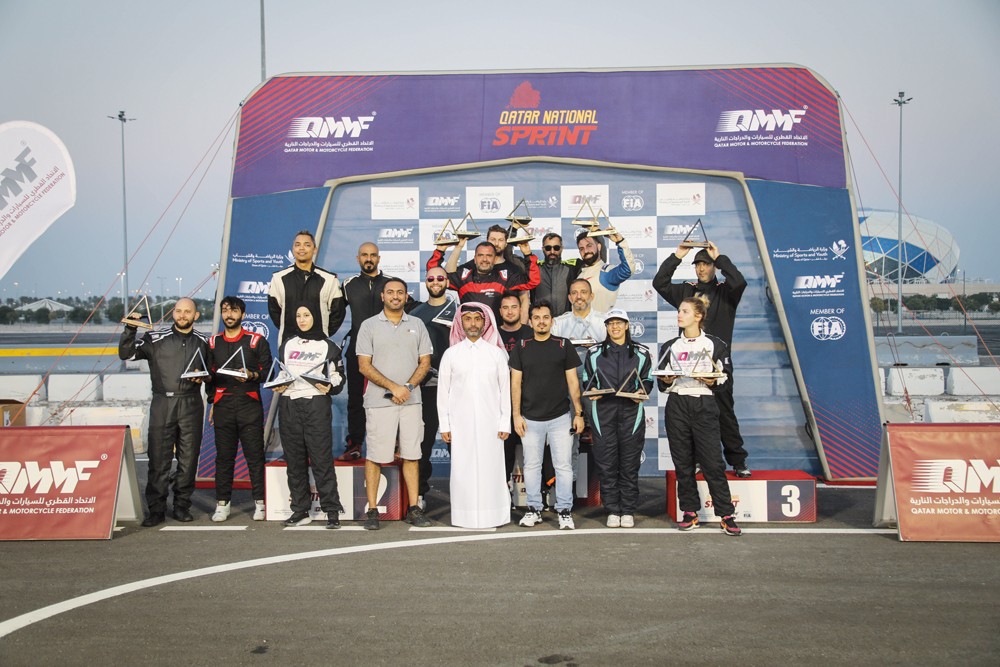 The Championship title winners and podium winners in the final round of the Qatar National Sprint pose for a photograph with officials.