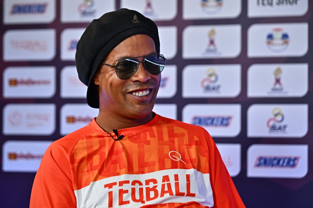 Former Brazilian football player Ronaldinho speaks to AFP during the World Teqball Championships at the Bangkok Arena in Bangkok on December 3, 2023. (Photo by Lillian Suwanrumpha / AFP)