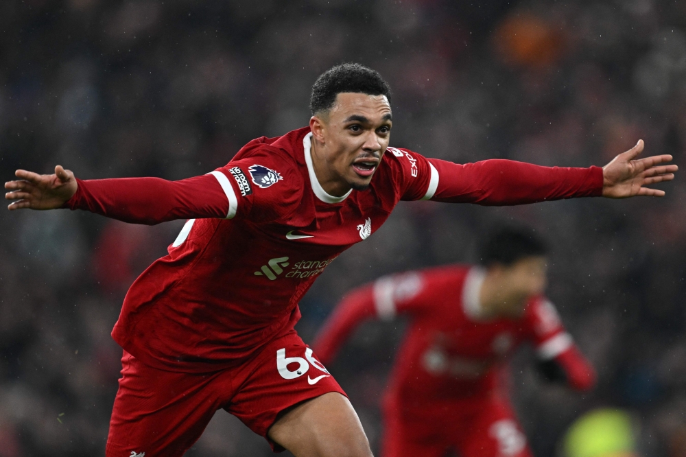 Liverpool's English defender #66 Trent Alexander-Arnold celebrates after scoring their fourth goal during the English Premier League football match between Liverpool and Fulham at Anfield in Liverpool, northwest England, on December 3, 2023. (Photo by Paul ELLIS / AFP)