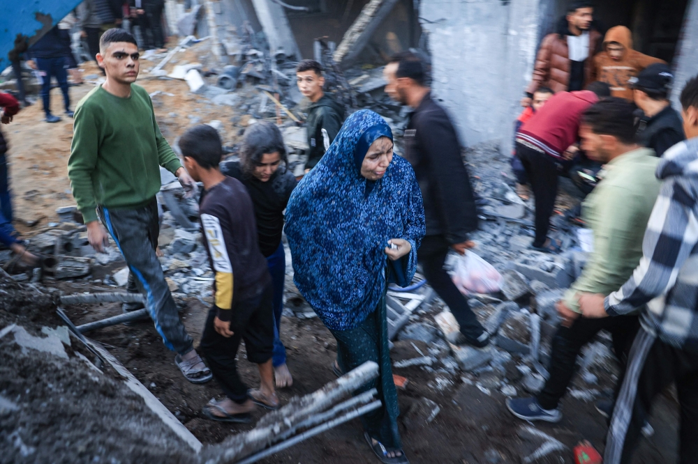 Palestinians check the damages after an Israeli strike in Rafah in the southern Gaza Strip on December 3, 2023. (Photo by Said Khatib / AFP)
