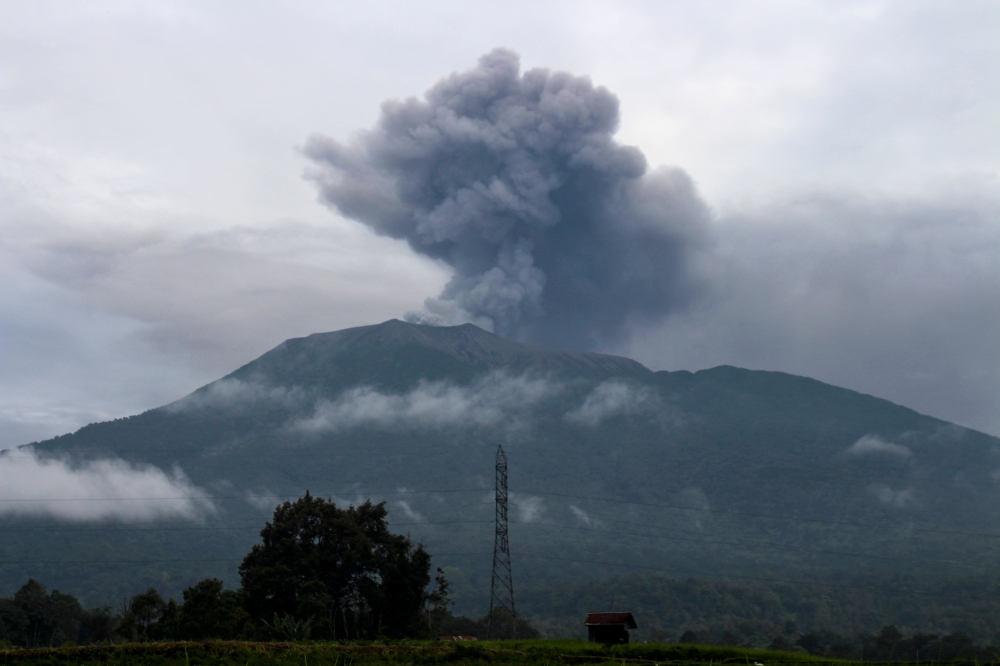 Volcanic ash spews from Mount Marapi during an eruption as seen from Batu Palano village in Agam on December 4, 2023. (Photo by Adi Prima / AFP)