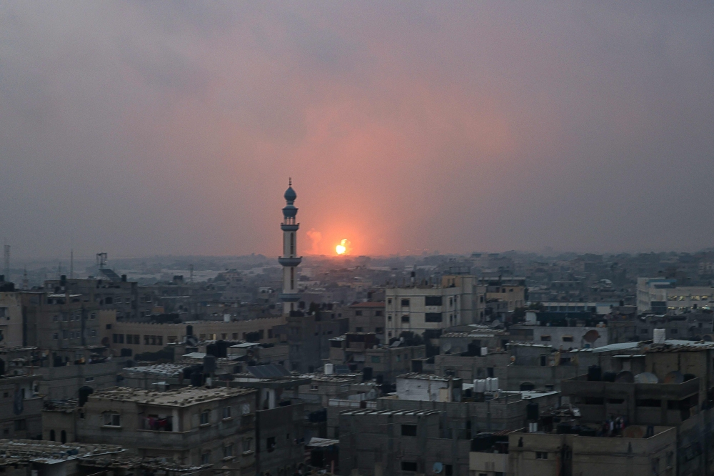 This picture taken on December 5, 2023 shows an explosion in Khan Yunis. (Photo by Mohammed ABED / AFP)