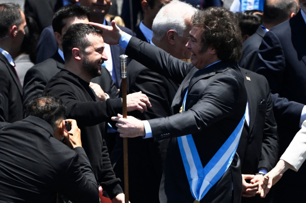 Argentina's new president Javier Milei (right) is greeted by Ukraine's President Volodymyr zelensky after delivering his inaugural speech before the crowd during an inauguration ceremony at the Congress in Buenos Aires on December 10, 2023. (Photo by Luis Robayo / AFP)