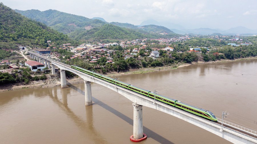 A train drives on the China-Laos Railway's Luang Prabang cross-Mekong River super major bridge in Laos, May 28, 2023. (Photo by Chen Chang/Xinhua)
