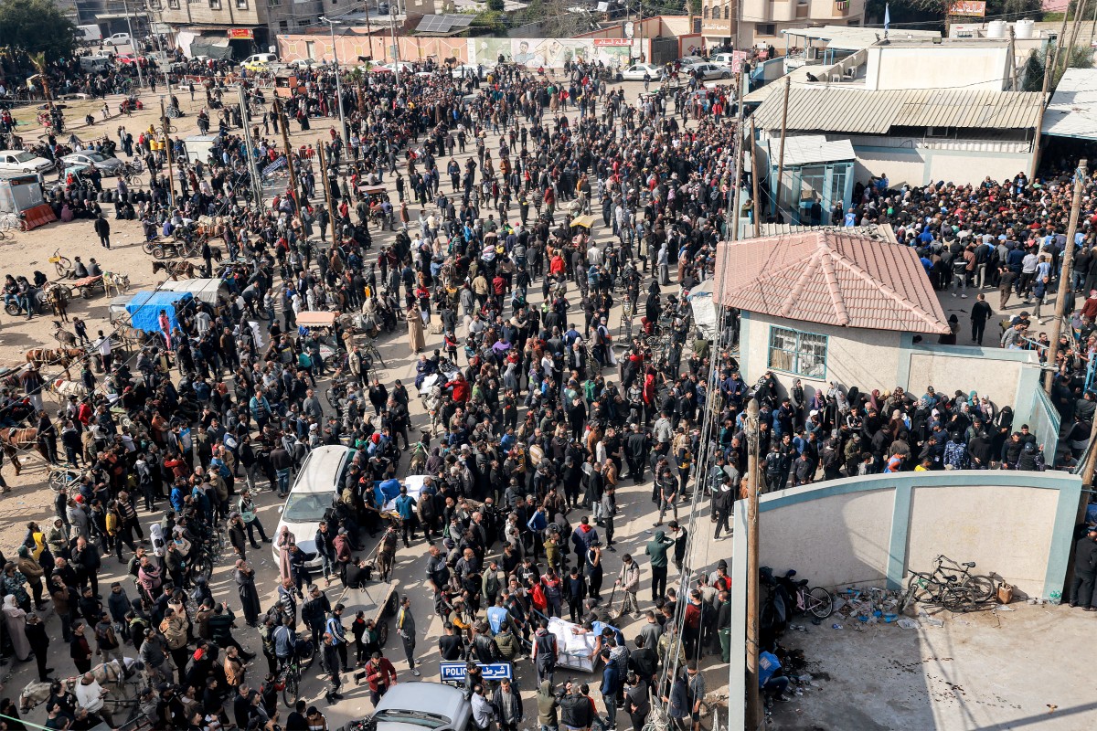 Palestinians gather to receive flour rations for their families outside a warehouse of the United Nations Relief and Works Agency for Palestine Refugees (UNRWA) in Rafah in the southern Gaza Strip on December 12, 2023. Photo by MOHAMMED ABED / AFP