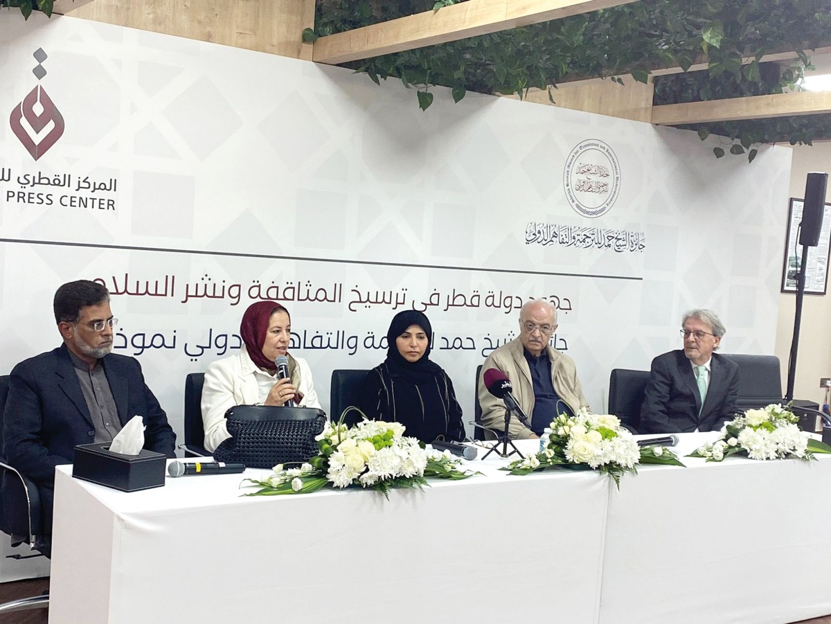 Spokesperson of Sheikh Hamad Award for Translation and International Understanding Dr. Hanan Al Fayyad (centre) with winners of the award during an event at Qatar Press Center yesterday.