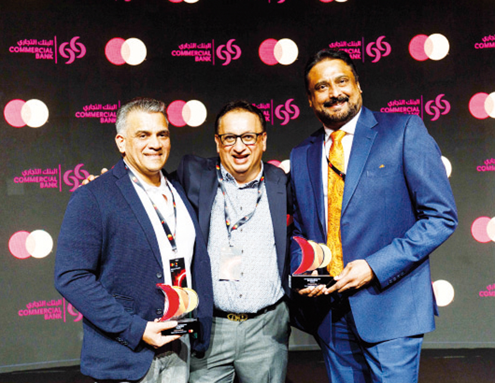 Commercial Bank officials with awards at the Mastercard MENA Business Forum.