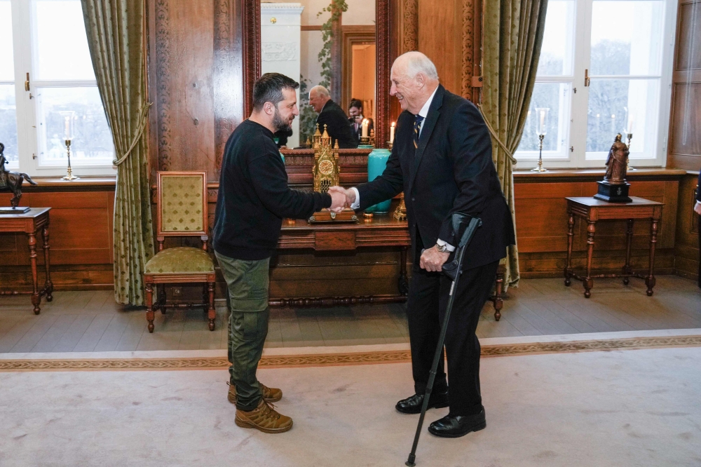 Ukrainian President Volodymyr Zelensky (right) is received by King Harald V of Norway at the Royal Palace in Oslo on December 13, 2023, after he attended a meeting with leaders of the five Nordic nations, key backers in Kyiv's fight against Russia's invasion. Zelensky spokesman said the president 