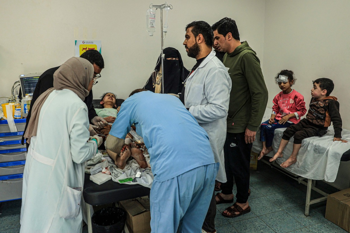 An injured Palestinian girls receives treatment at the Kuwait hospital following Israeli bombardment in Rafah, in the southern Gaza Strip yesterday.  (AFP)