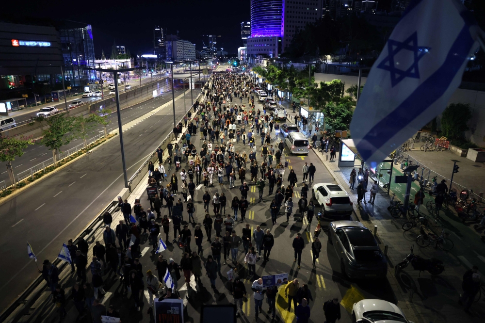 Relatives and supporters of hostages held by Palestinian militants demonstrate outside the Israeli ministry of defence in Tel Aviv on December 15, 2023. (Photo by AHMAD GHARABLI / AFP)