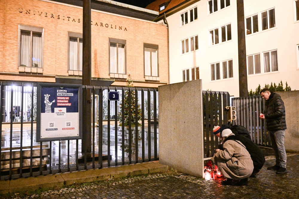 Well wishers light candles for the shooting victims at the Charles University main office in central Prague, on December 21, 2023. Photo by Michal CIZEK / AFP