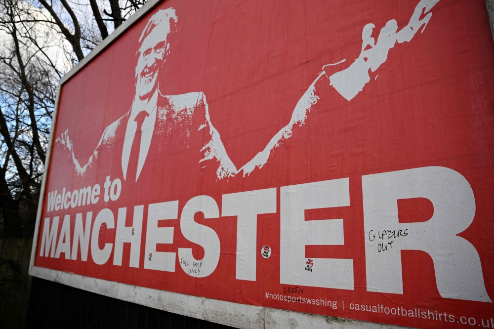 A poster showing British INEOS Group chairman Jim Ratcliffe is seen outside the ground ahead of the English Premier League football match between Manchester United and Bournemouth at Old Trafford in Manchester, north west England, on December 9, 2023.(Photo by Oli SCARFF / AFP)
