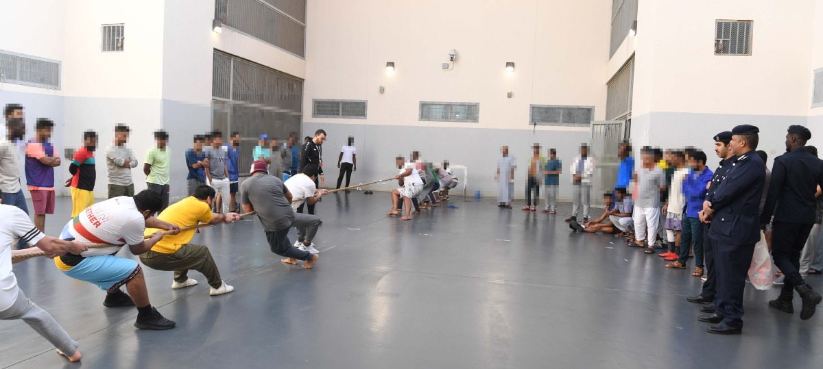 Officials watch as inmates take part in a sports competition. 