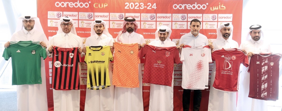 Club representatives hold their team jerseys following a technical meeting held yesterday.