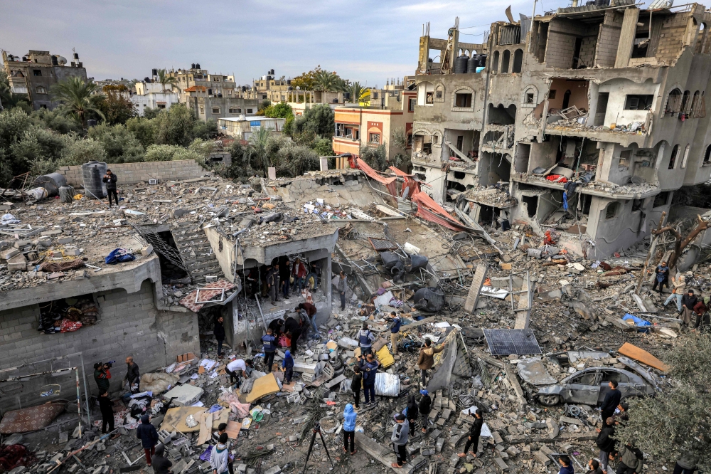 The aftermath of an overnight Israeli strike at al-Maghazi refugee camp on December 25, 2023. (Photo by Mahmud Hams / AFP)
 