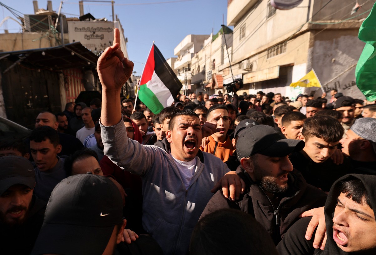 Mourners attend the funeral procession of two men killed in an Israeli army incursion in the al-Fawwar refugee camp, south of Hebron in the occupied West Bank, on December 26, 2023. Photo by HAZEM BADER / AFP