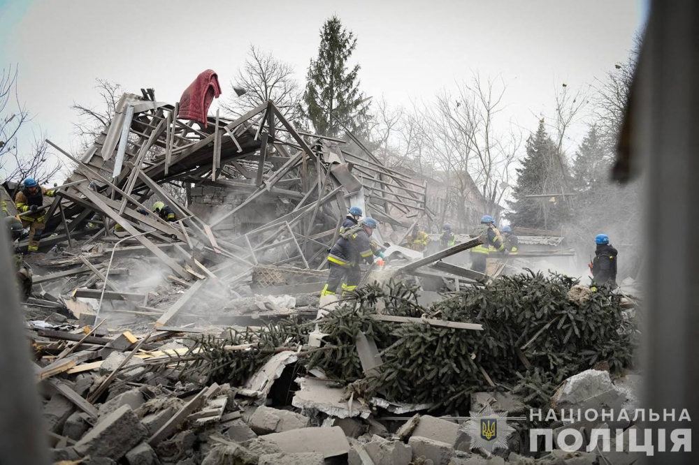 This handout photograph taken and released by the National Police of Ukraine on December 29, 2023, shows Ukrainian firefighters and policemen working at a site after a rocket attack in the city of Zaporizhya, amid the Russian invasion of Ukraine. Photo by Handout / National Police of Ukraine / AFP