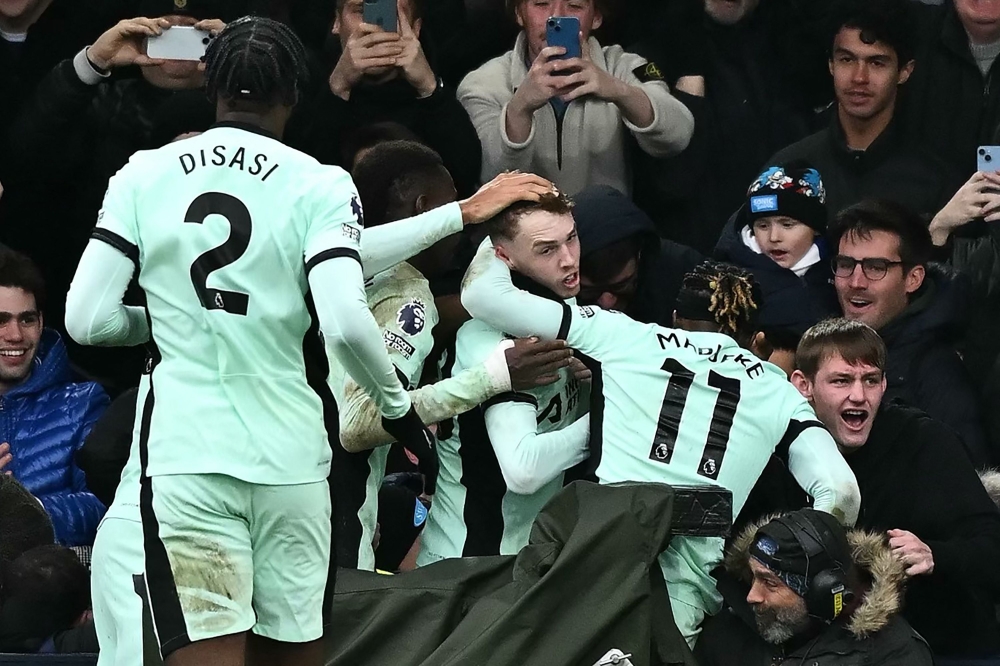 Chelsea's English midfielder #20 Cole Palmer (C) celebrates with Chelsea fans after scoring their third goal during the English Premier League football match between Luton Town and Chelsea at Kenilworth Road in Luton, north of London on December 30, 2023. (Photo by Ben Stansall / AFP)
