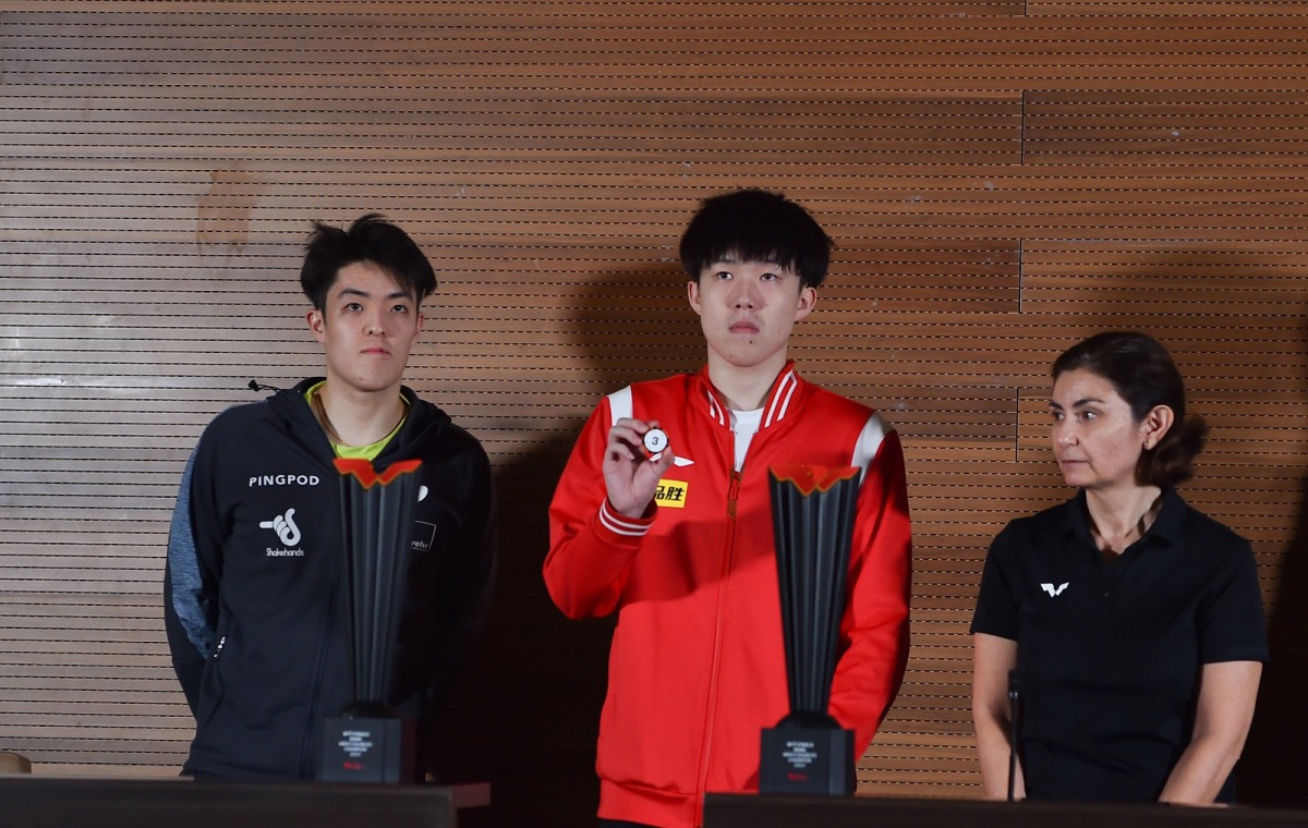 Germany's Dang Qiu and China's Wang Chuqin provided assistance during the official draw ceremony held in Doha, yesterday.