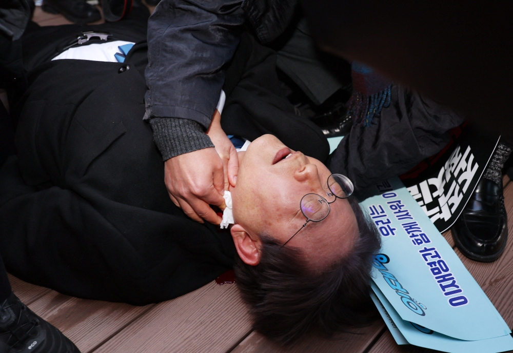 South Korean opposition party leader Lee Jae-myung is attended to after being attacked in Busan on January 2, 2024. Photo by YONHAP / AFP