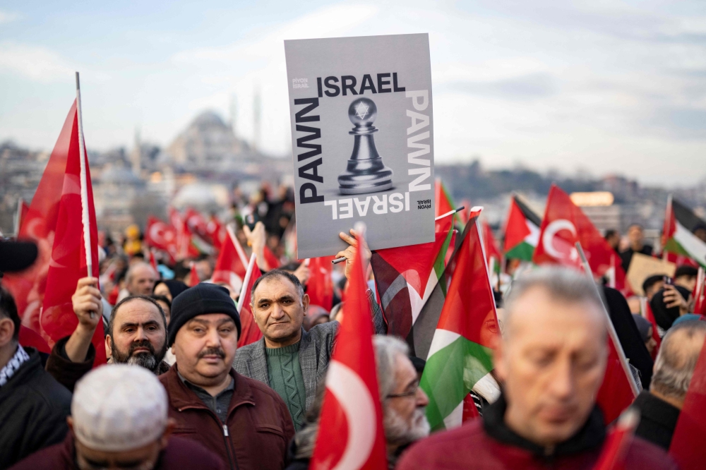 Thousands demonstrate to show solidarity with the Palestinian people at the Galata Bridge in Istanbul on January 1, 2024. (Photo by Yasin Akgul / AFP)