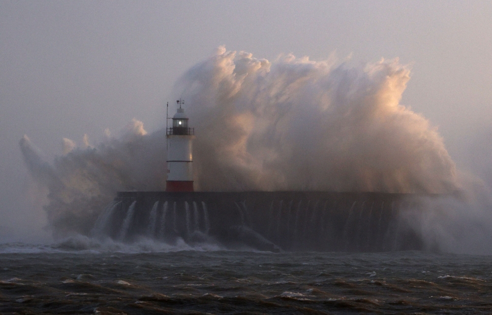 Waves crash over Newhaven Lighthouse and the breakwater in Newhaven on January 2, 2024, as Storm Henk brought strong winds and heavy rain across much of southern England. Photo by ADRIAN DENNIS / AFP