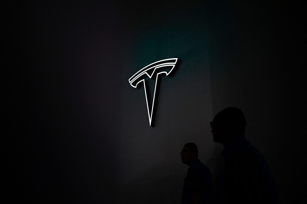 The Tesla logo is seen during the World Artificial Intelligence Conference (WAIC) in Shanghai on July 7, 2023. Photo by WANG Zhao / AFP