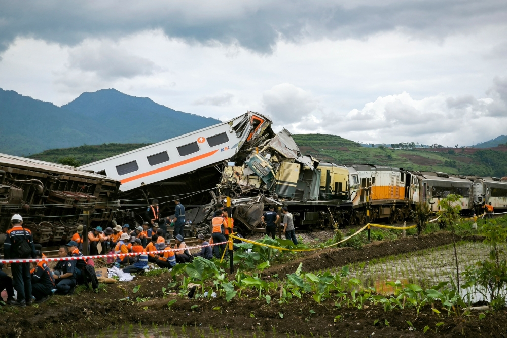 Search and rescue teams work at the scene of a train accident in Cicalengka, West Java province on January 5, 2024. Photo by ADI MARSIELA / AFP