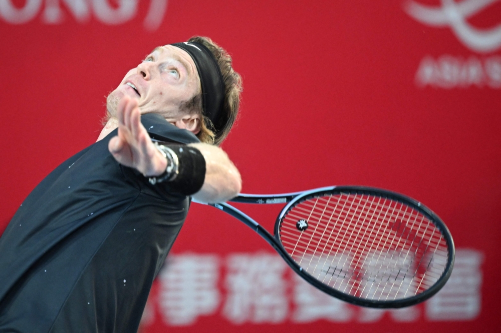 Russia's Andrey Rublev serves to China's Shang Juncheng during their men's semi-final singles tennis match at the Hong Kong Open in Hong Kong on January 6, 2024. (Photo by Peter Parks / AFP)