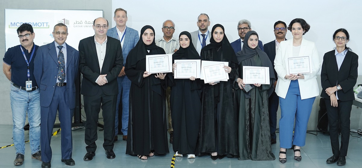 A group photo of the winning team in QU Business Challenge with officials.