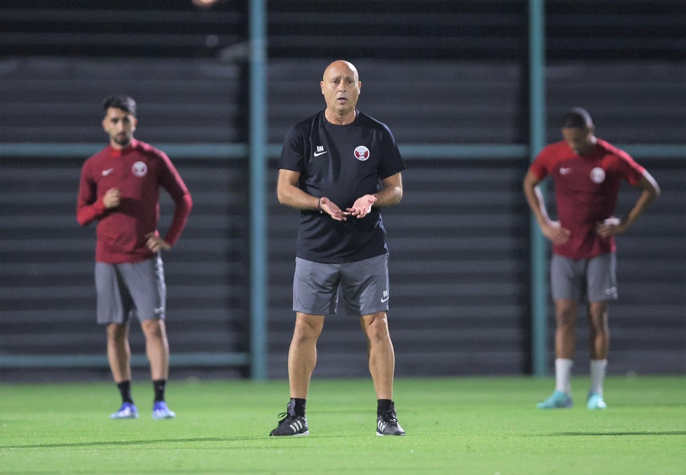 Qatar coach Marquez Lopez supervises team's training session.