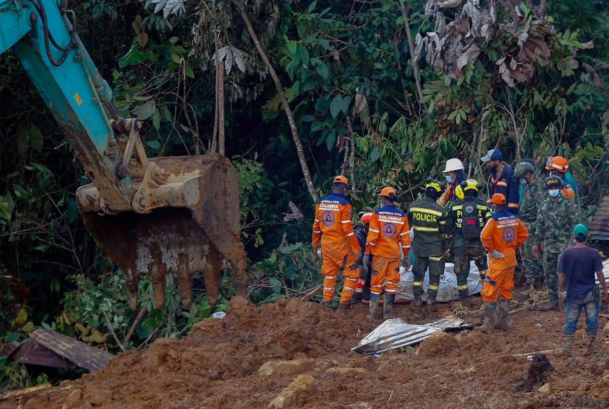 Members of the rescue team find a corpse of a victim in the area of a landslide in the road between Quibdo and Medellin, Choco department, Colombia on January 14, 2024. Photo by Fredy Builes / AFP