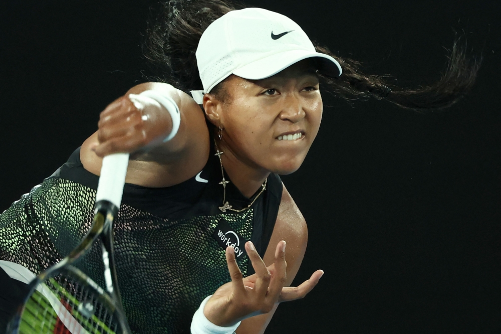 Japan's Naomi Osaka serves against France's Caroline Garcia during their women's singles match on day two of the Australian Open tennis tournament in Melbourne on January 15, 2024. (Photo by David GRAY / AFP)