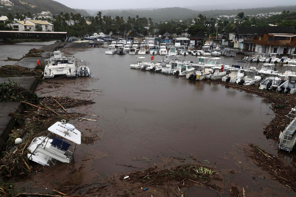 A photo shows damages and boats in a marina after the passage of cyclone Belal in Saint-Paul, on the French Indian Ocean island of La Reunion, on January 15, 2024. (Photo by Richard Bouhet / AFP)