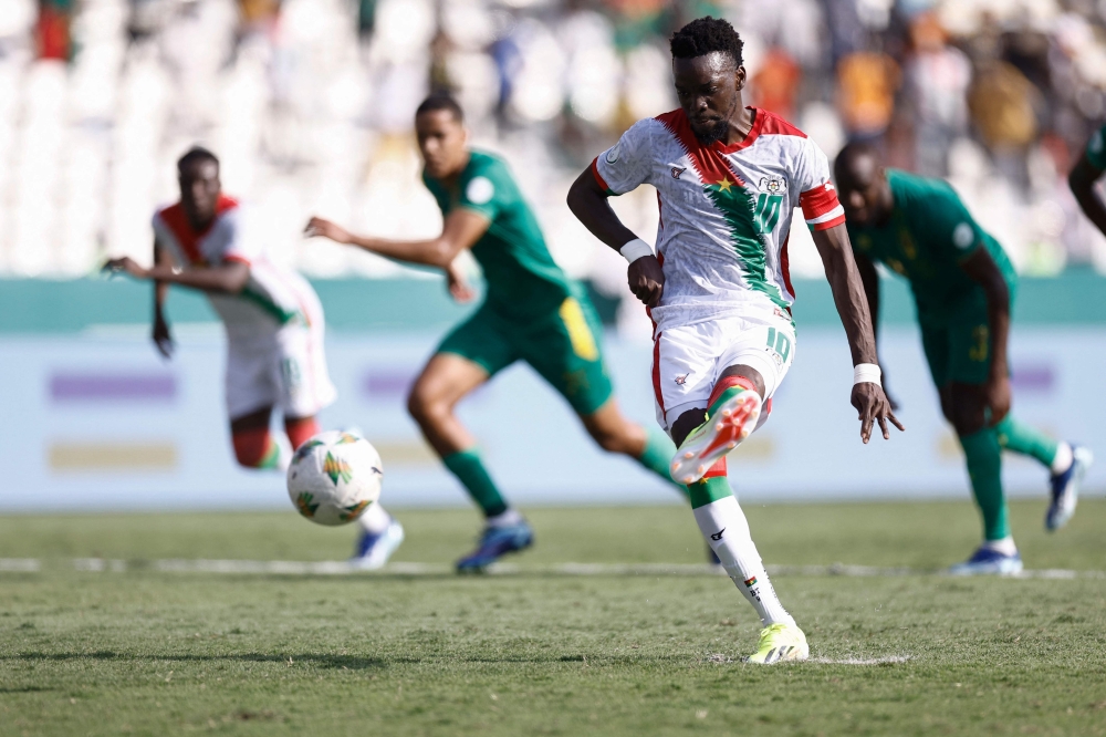 Burkina Faso's forward #10 Bertrand Traore shoots and scores his team's first goal from a penalty kick during the Africa Cup of Nations (CAN) 2024 group D football match between Burkina Faso and Mauritania at Stade de la Paix in Bouake on January 16, 2024. (Photo by KENZO TRIBOUILLARD / AFP)