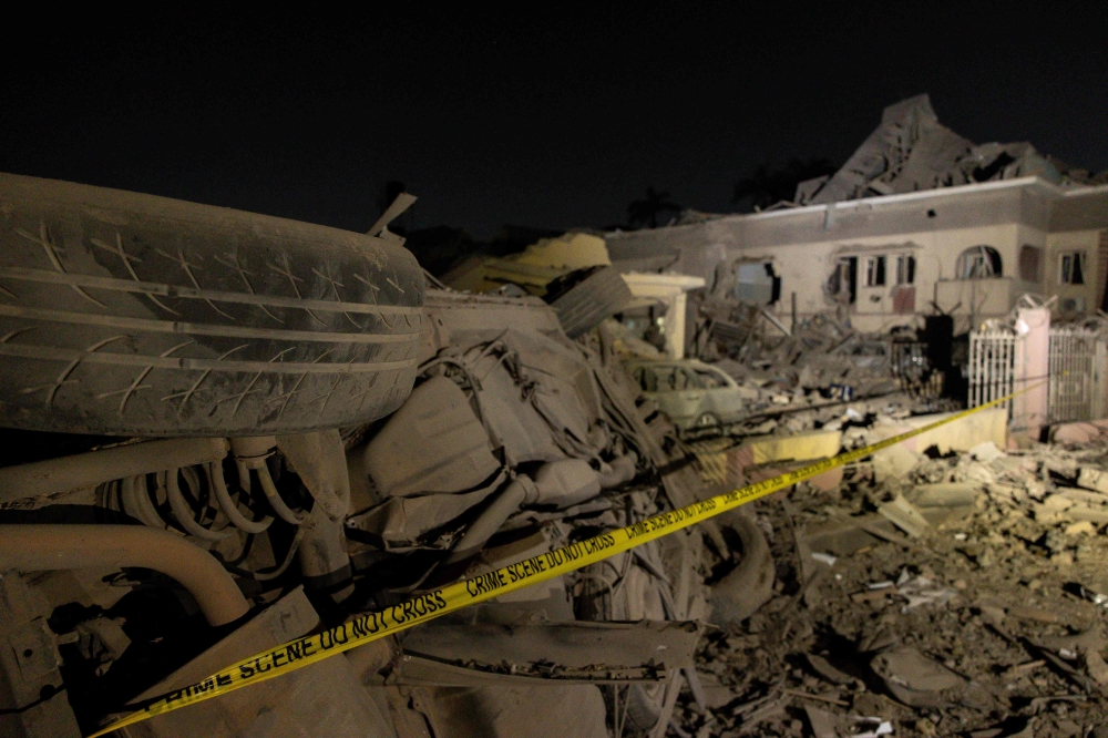 A general view of damaged cars and buildings at the scene of an explosion in the Bodija area in Ibadan on January 16, 2024. Photo by Samuel Alabi / AFP