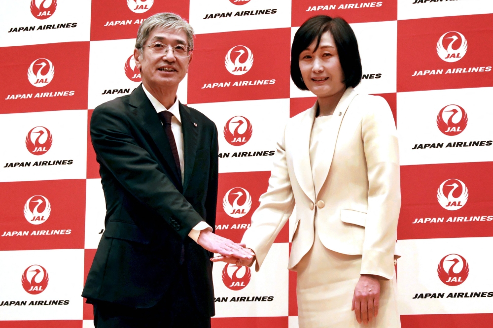 Japan Airlines' Senior Managing Executive Officer Mitsuko Tottori (R) and current president Yuji Akasaka pose for the media on January 17, 2024. (Photo by JIJI Press / AFP) 